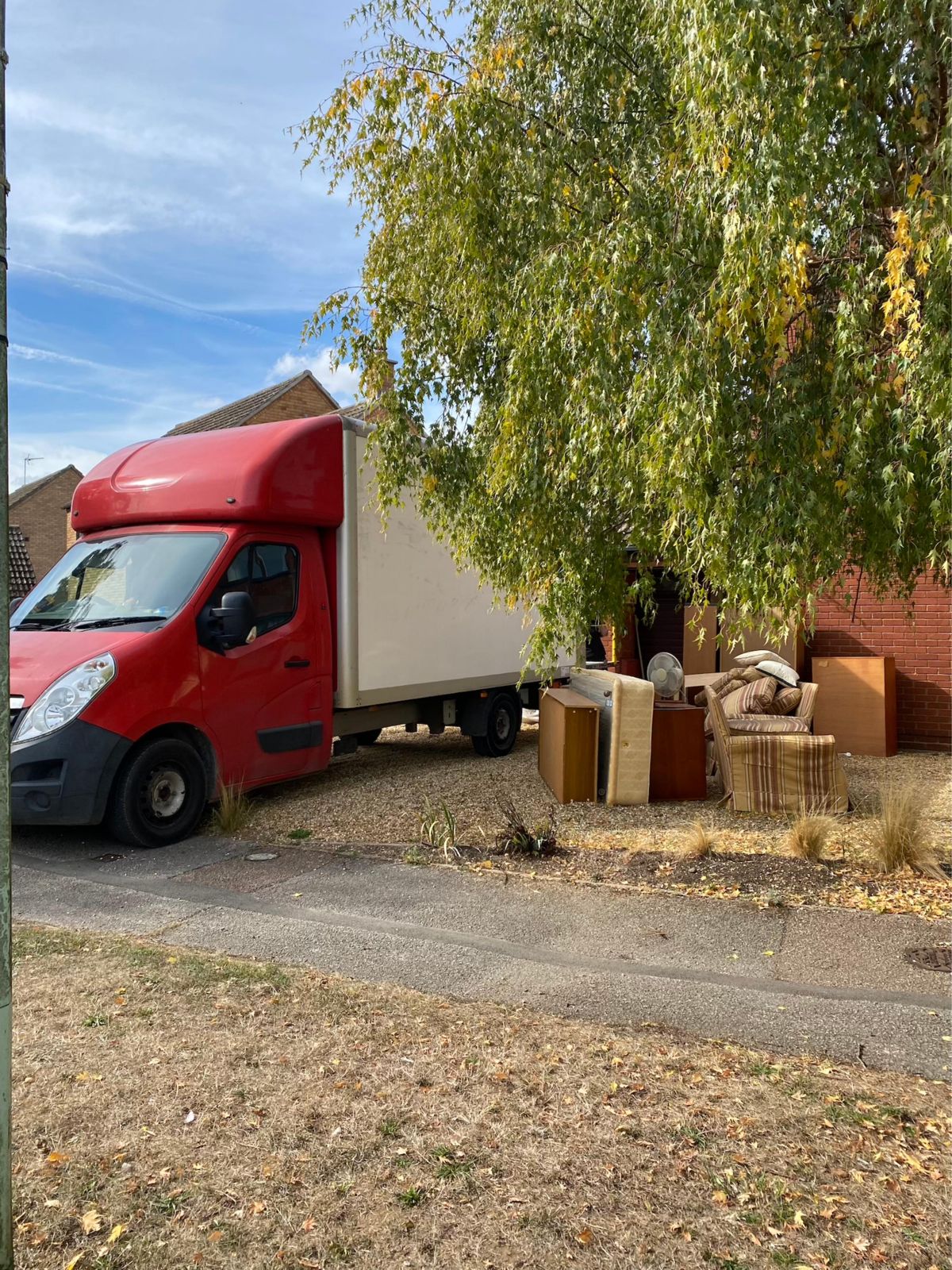 Van on the driveway with items waiting to be loaded